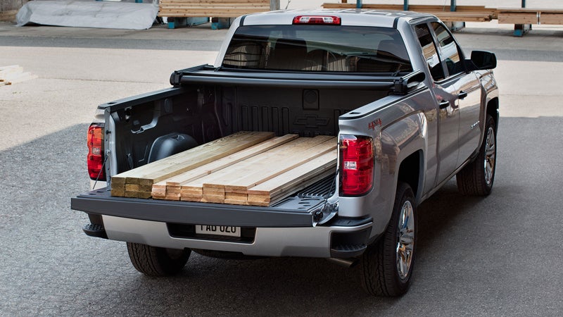 Silver 2018 Chevy Silverado with lumber in truck bed