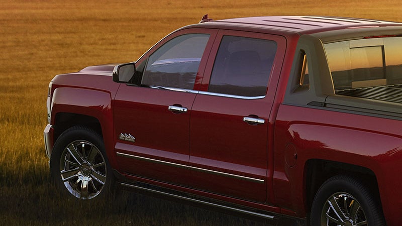 Red 2018 Chevy Silverado in a grass field