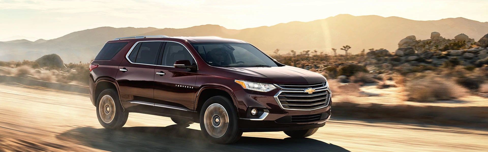 Burgundy 2018 Chevy Traverse driving in desert