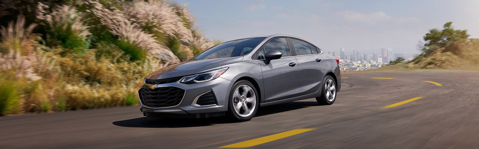 Silver 2019 Chevy Cruze driving on city highway