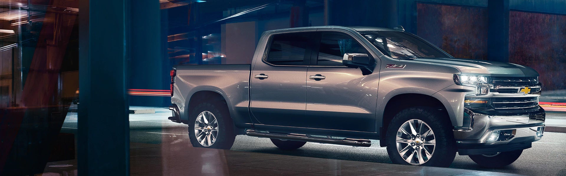 Silver 2019 Chevy Silverado 1500 driving at night