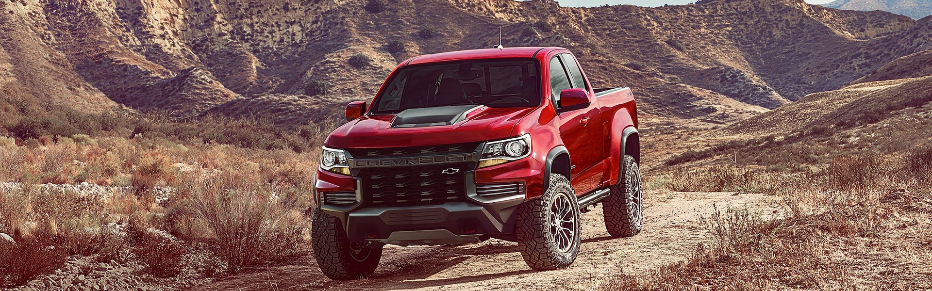 Red 2021 Chevrolet Colorado driving in desert