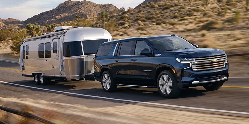 Chevy Suburban hauling Airstream trailer through desert
