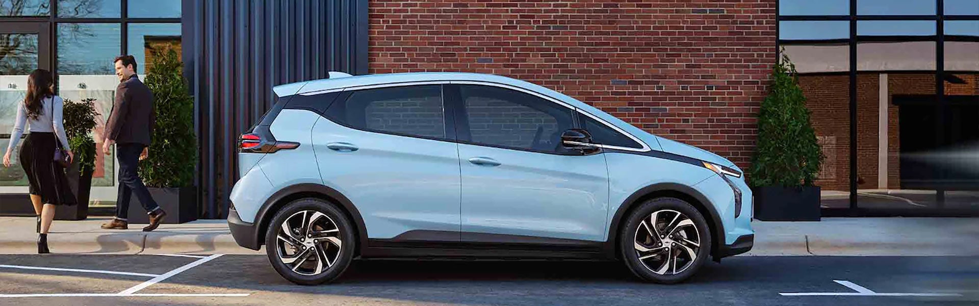 White 2022 Chevy Bolt EV in front of brick building