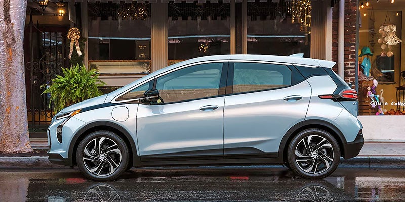 White 2022 Chevy Bolt EV parked downtown