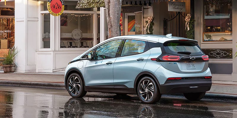 White 2022 Chevy Bolt EV in downtown city
