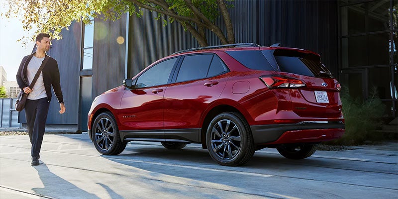 Red Chevrolet Equinox driving away