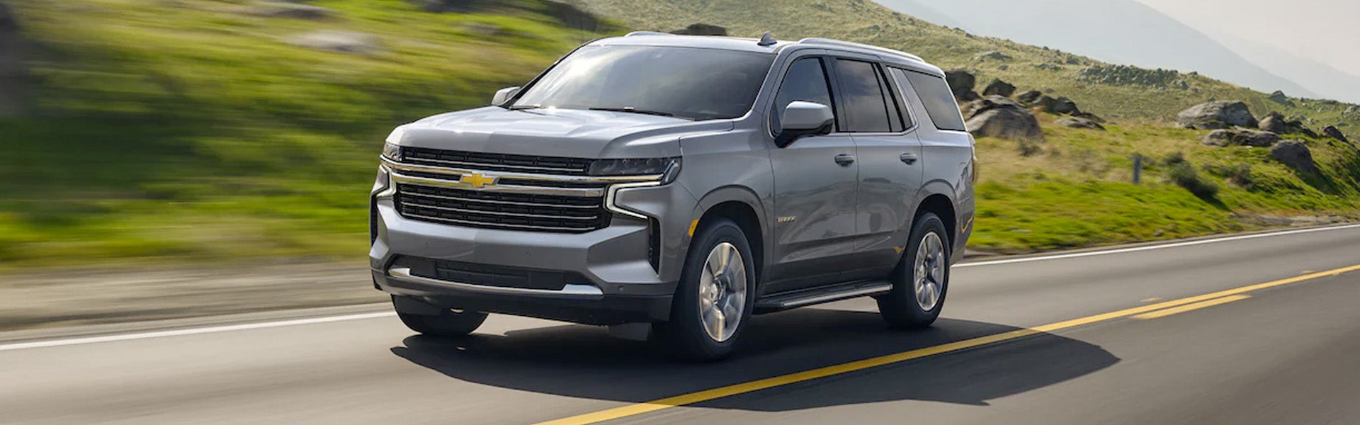 Silver 2022 Chevy Tahoe driving in country