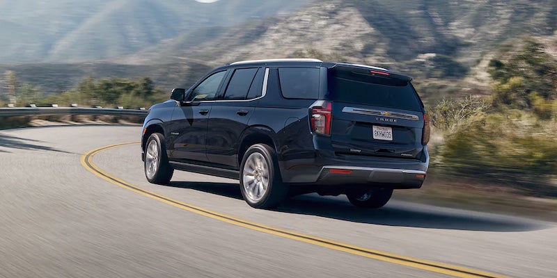 Black 2022 Chevy Tahoe driving in mountains