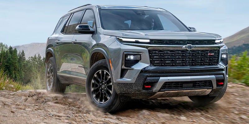 Trailblazer parked on top of a boulder while it is sunny outside