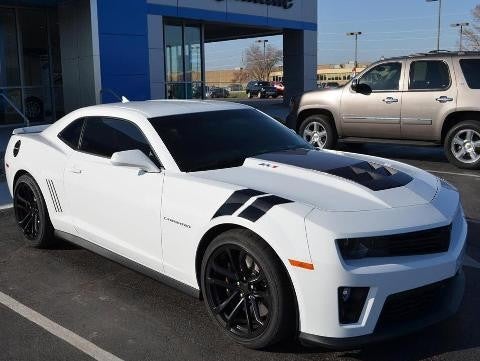 White Mustang parked in front of Murdock Manhattan Chevrolet Dealership