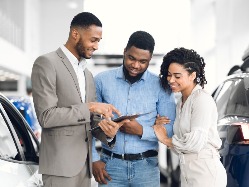 service manager showing all documents to customers before buying a vehicle