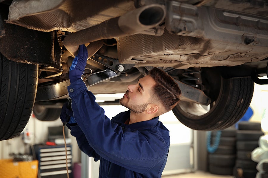 Mechanic taking care of your vehicle when you bring into service at Murdock Manhattan Chevrolet
