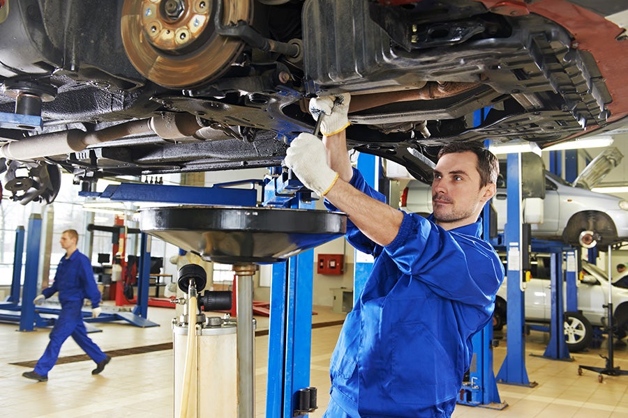 Mechanic chaning the oil of a brand new Chevrolet vehicle